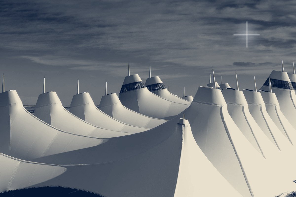 Peaked white roof of the Denver International Airport terminal against the sky