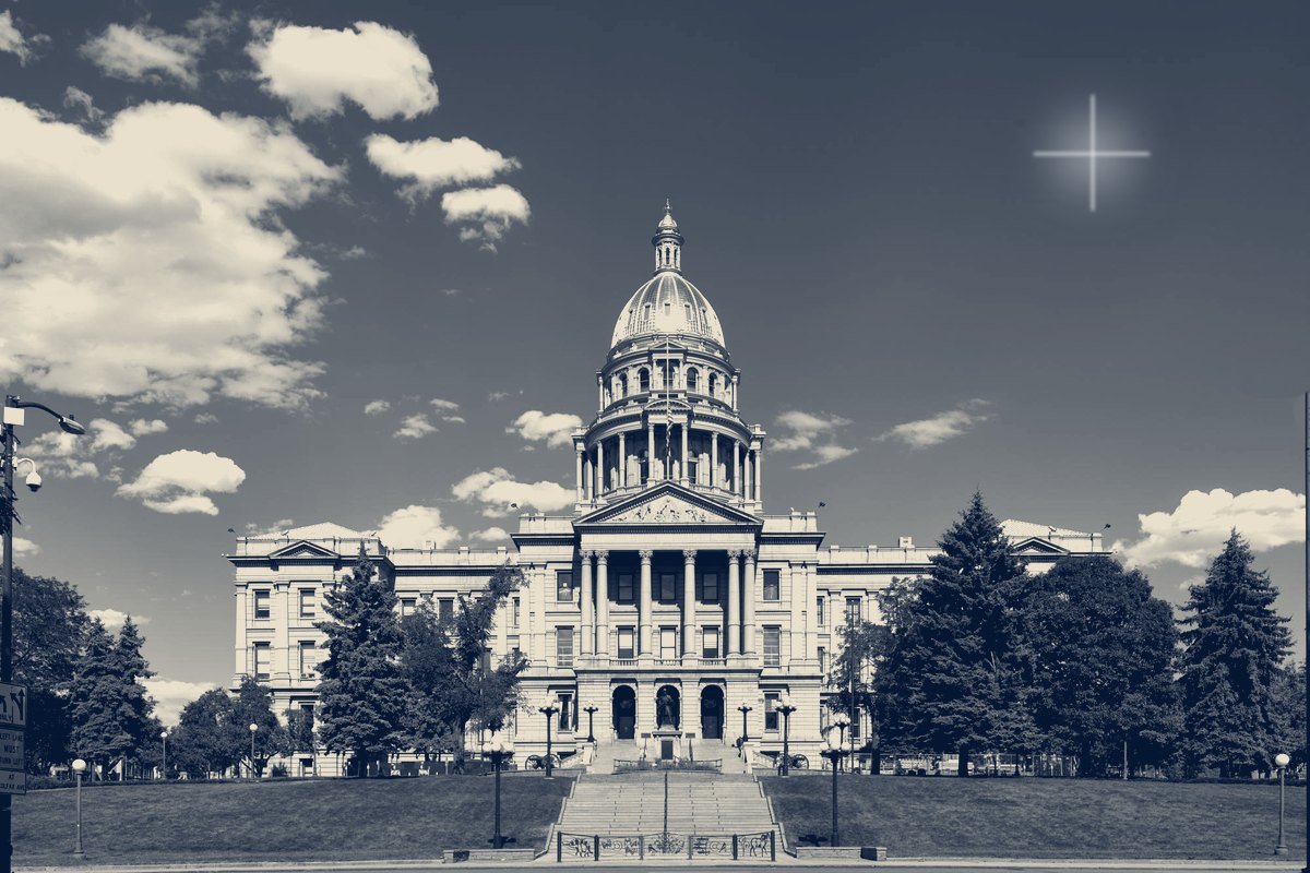 The gold-domed Colorado State Capitol in Denver under a partly cloudy sky